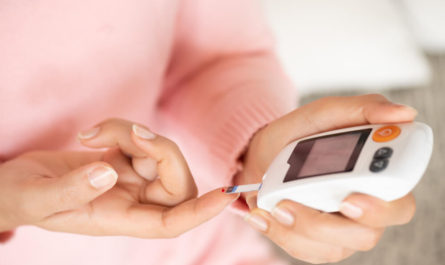 woman hands checking blood sugar level