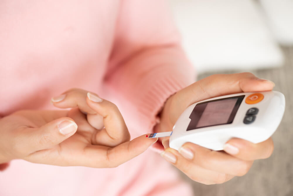 woman hands checking blood sugar level